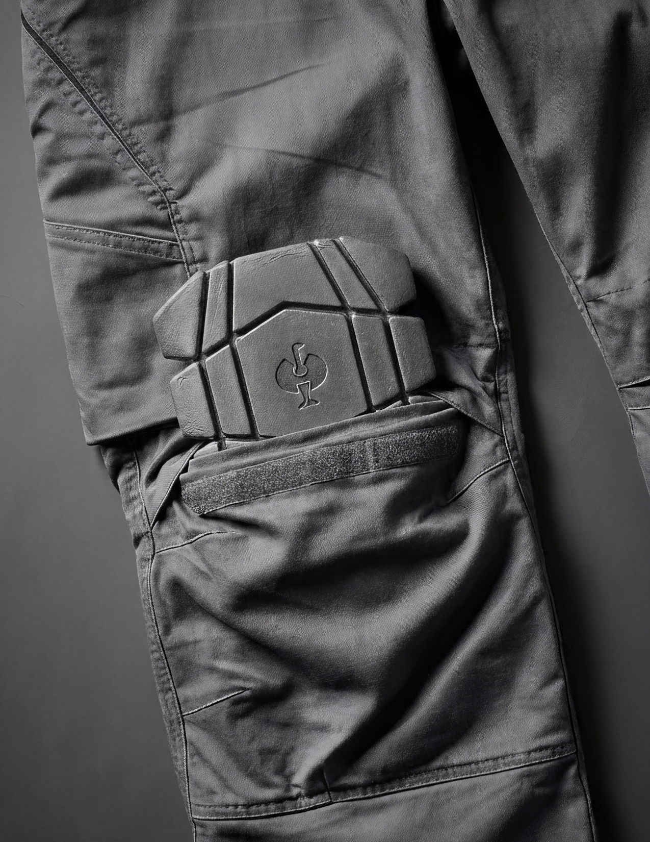 Close-up of gray pants with a knee pad 
