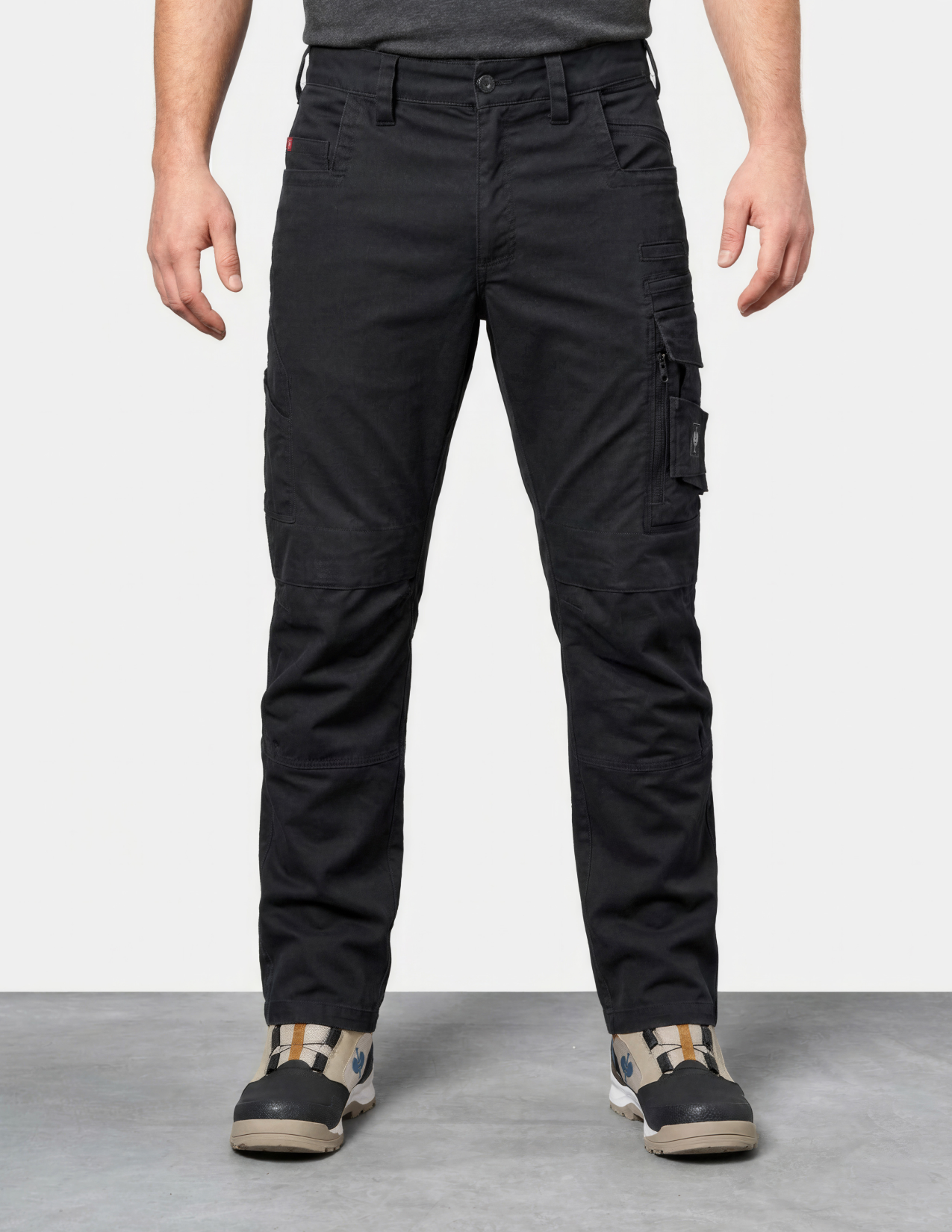 Person wearing black cargo pants on a white background