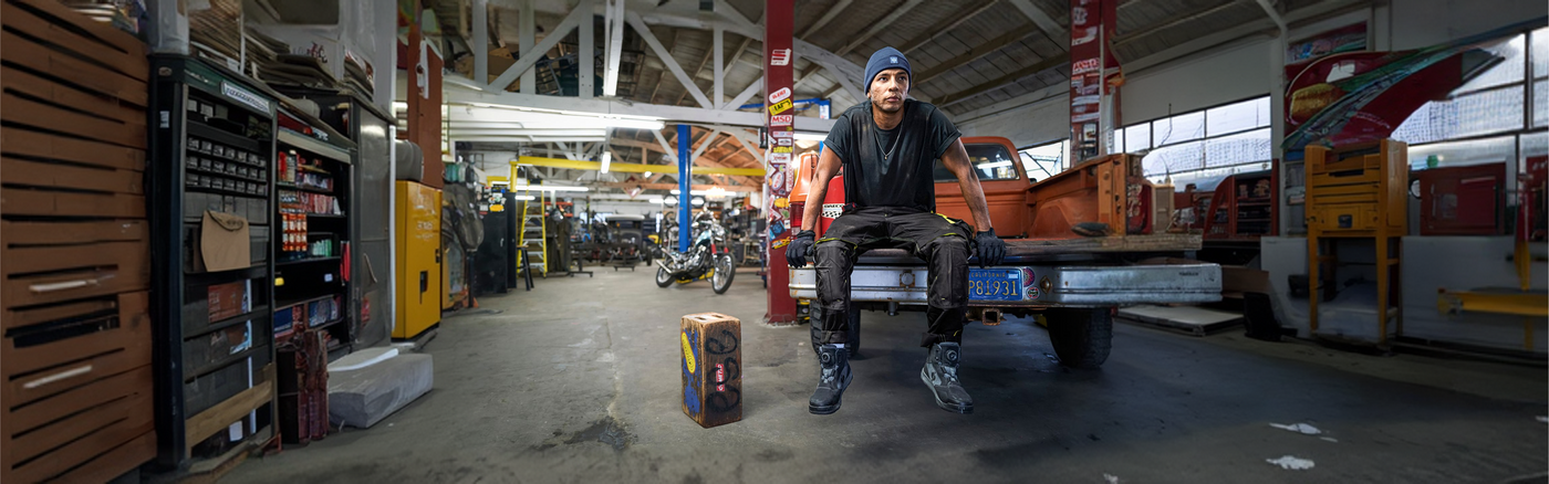A man sitting on the trunk of a car