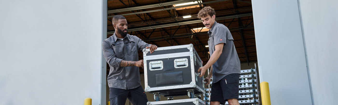Two men unloading boxes from a warehouse