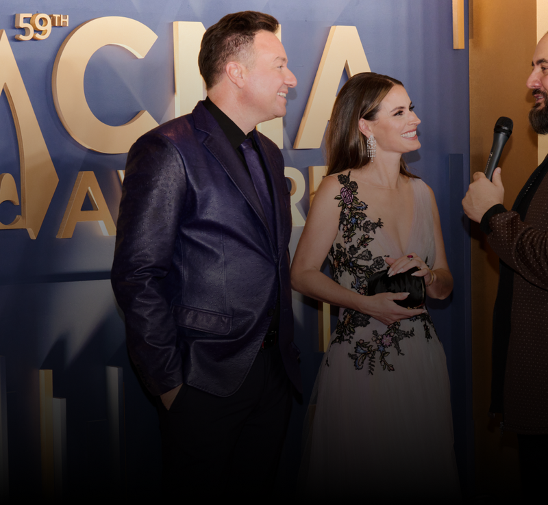 Henning Strauss and his wife on the red carpet at the 59th CMA Awards