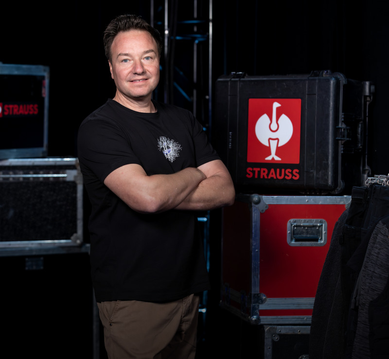 Henning Strauss standing with his arms crossed