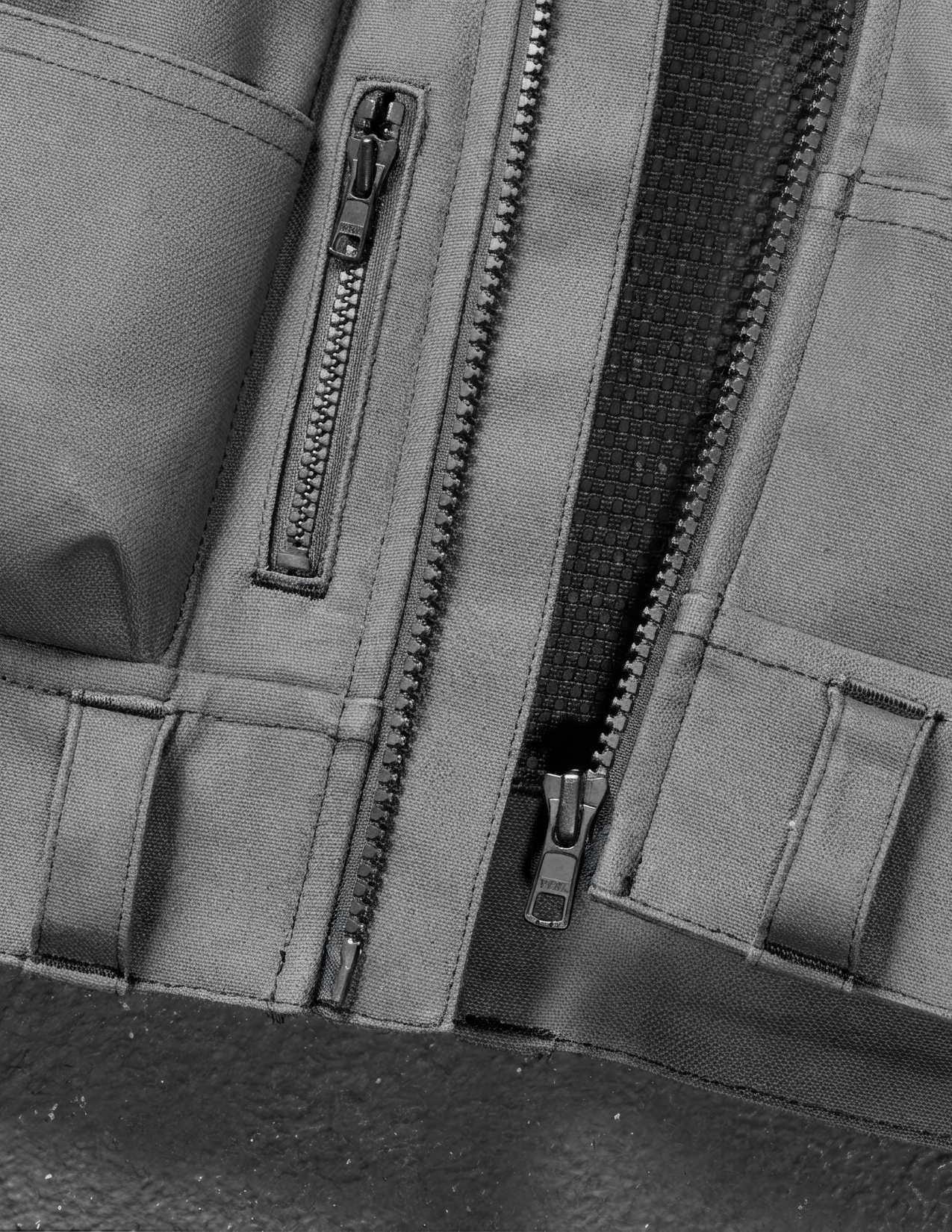 Close-up of a zipper on a vest with a focus on texture and detail.