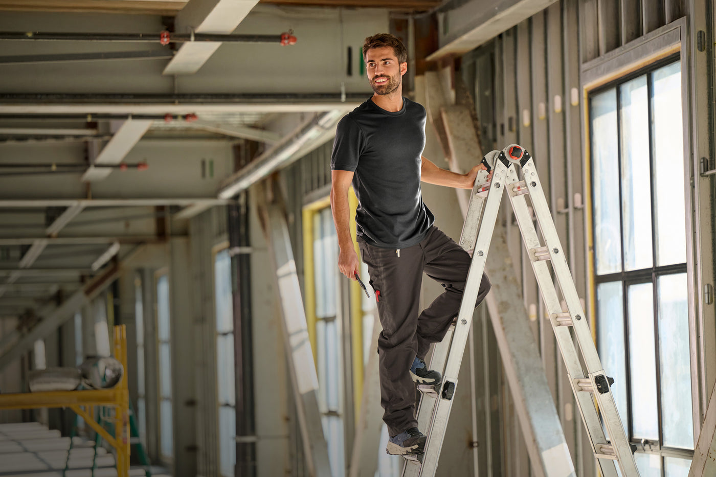Electrician stands on ladder